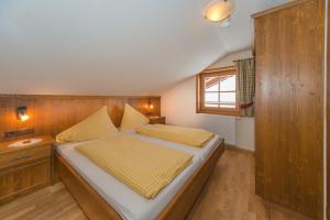 a bedroom with a bed with a wooden headboard at Glösalm in Ramsau am Dachstein