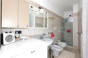 a bathroom with a sink and a toilet and a shower at Central Luxury Apt w Garage Happy Home Bergamo in Bergamo