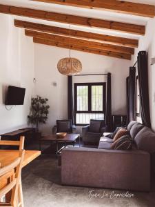 a living room with a couch and a table at Finca Caprichosa in Cortelazor