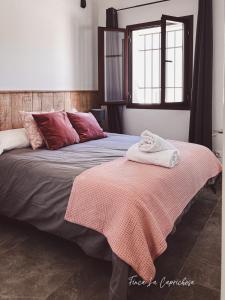 a bedroom with a bed with a blanket on it at Finca Caprichosa in Cortelazor