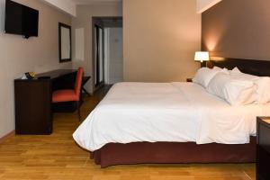 Postel nebo postele na pokoji v ubytování Hotel Crans Montana