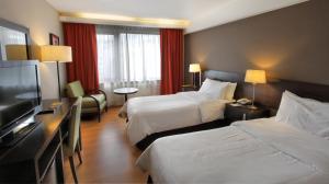 Postel nebo postele na pokoji v ubytování Hotel Crans Montana