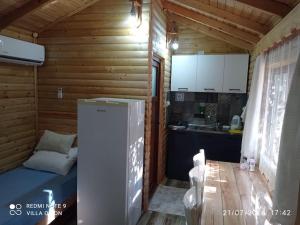 a small kitchen with a refrigerator in a cabin at Finike Bungalow Orion in Finike