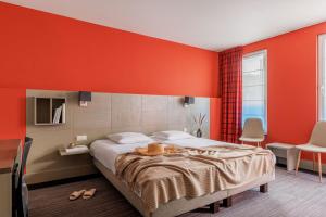 a bedroom with a large bed with orange walls at Pantheon Palace By WP Hotels in Blankenberge
