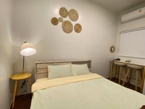 a bedroom with a bed and a table and a window at 3BR 5BedVilla Silom China town BTS Surasak Special offer in Chinatown