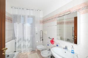 a bathroom with a sink and a toilet and a mirror at Central Luxury Apt w Garage Happy Home Bergamo in Bergamo +37 photos