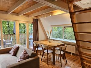 a living room with a table and a couch at Les Jardins de Durbuy in Durbuy