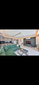 a living room with a green couch and a table at Villa simurg in Kas