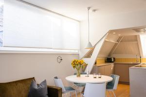 a kitchen and dining room with a table and chairs at OHotellMe City Apartments Rotterdam in Rotterdam