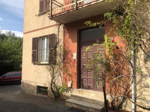 a house with a purple door and a window at AL CASTELLO Cengio Alto in Cengio