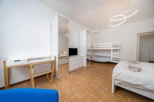 a room with a bed and a desk and a bed sidx sidx sidx at Cividale Medieval Town Apartment in Cividale del Friuli