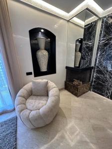 a living room with a white chair and a mirror at Centre Zara 2BR in Marrakech +69 photos