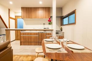 a kitchen and dining room with a wooden table at HOTEL Shibuya Tomigaya in Tokyo