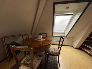 a table and chairs in a room with a window at City View & Central Location in Trondheim