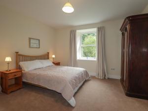 Postel nebo postele na pokoji v ubytování Gunroom Cottage