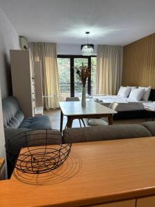 a living room with a couch and a bed at Sandanski Apartments Park Center in Sandanski