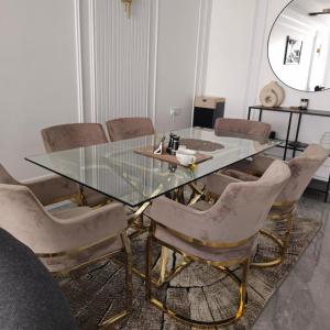 a dining room with a glass table and chairs at Luxury apartment, kilimani in Nairobi +4 photos