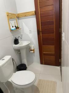 a bathroom with a toilet and a sink at Temporada BHS Quarto 2 in Barreirinhas