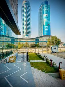 a parking lot in front of a building with tall buildings at Elysium Luxury 1Bed Apartment! Opposite to Centaurus Mall in Islamabad