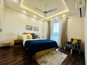 a bedroom with a bed and a large window at Elysium Luxury 1Bed Apartment! Opposite to Centaurus Mall in Islamabad