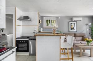 a kitchen and living room with a couch and a table at STUDIO VILLA NUI in Cuers