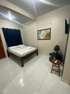a room with a bed and a chair in it at Temporada BHS Quarto 3 in Barreirinhas +3 photos