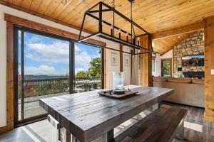 a large wooden table in a room with a large window at Wishlist in Beech Mountain