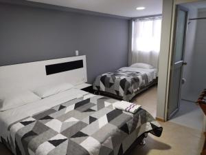 Ένα ή περισσότερα κρεβάτια σε δωμάτιο στο Hotel y Cabañas Rio Mayo