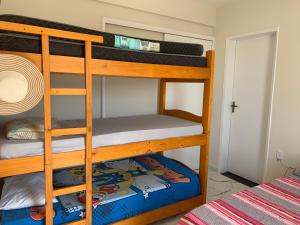 two bunk beds in a room with a bed at Riviera Massaguaçu in Massaguassu