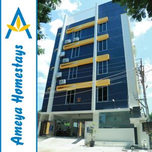 a blue building with a star on the side at Ameya Homestays Brand New Fully Furnished 3BHK & 2BHK Apartments. in Tirupati