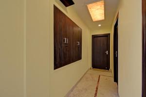 a hallway with wooden cabinets and a door at Collection O Ketan Regency Near Acropolis Mall in Kolkata
