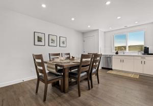 a kitchen and dining room with a table and chairs at Livingston Way I Sleep 6 I Netflix I Kitchen I TV in Pincher Creek