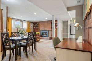 a kitchen and dining room with a table and chairs at 2BR Cozy Suite w Fireplace! FREE Banff Pass, Parking, Netflix! Enjoy Yoga Classes or Plan Your Golf Trip! in Calgary