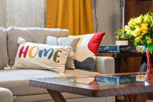 a couch with pillows on it with a coffee table at 2BR Cozy Suite w Fireplace! FREE Banff Pass, Parking, Netflix! Enjoy Yoga Classes or Plan Your Golf Trip! in Calgary