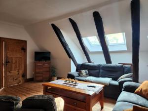 a living room with a couch and a table at Hof KuMa in Uelzen