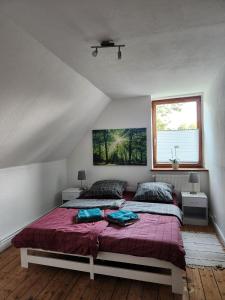 a bedroom with a large bed with a purple blanket at Hof KuMa in Uelzen