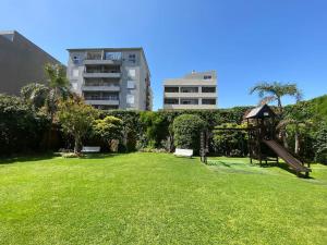 a park with a playground and a swing at Tigre Center Tower - Con piscina y seguridad 24hs - Opcional cochera in Tigre