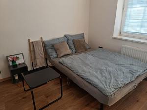 a bedroom with a large bed with a table at Červená cesta in Kunowitz