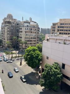 a parking lot with parked cars in a city at جاردن سيتى in Cairo