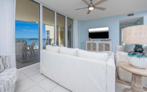 a living room with a white couch and a table at FL-Beach Colony East E3B condo in Pensacola