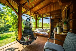 a hammock in the middle of a screened in porch at Wapienne domek in Sękowa