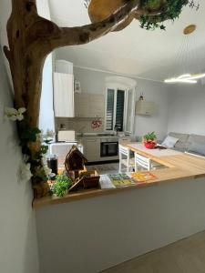a kitchen with a counter with a table in it at Il Casale Appartamento Assisi in Assisi