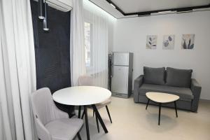 a living room with a table and a couch at Nice and cosy in Arabkir