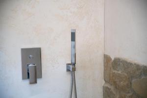 a toilet paper dispenser on the side of a wall at Ciabot Donna Rosa in Santo Stefano Belbo
