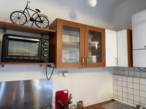 a kitchen with a microwave and a bike on top of it at Apartman Meda in Varaždin