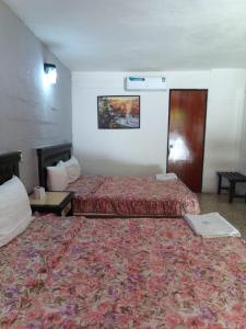 a hotel room with two beds and a table at Hotel Narváez Dorado Centro de Convenciones in Tuxtla Gutiérrez +32 photos