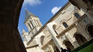 a church with a clock tower in the background at La chambre d'Hôt'ize in Bouillé-Courdault