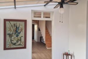a hallway with a ceiling fan and a painting on the wall at Côté Loire in La Charité-sur-Loire +26 photos