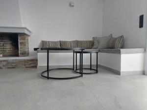 a living room with a bench and a fireplace at Apomero Apartment in Rochari Panormos in Panormos