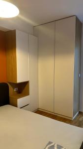 a bedroom with white cabinets and a bed at Sara apartment in Skopje +7 photos